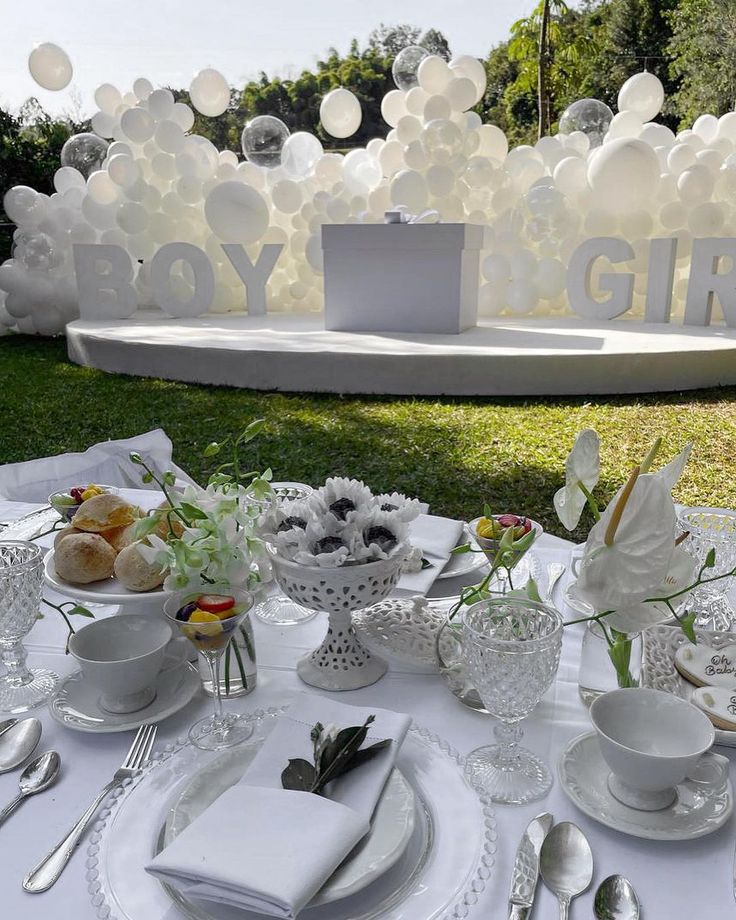 the table is set with white dishes and silverware