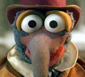 a close up of a bird wearing a top hat and coat with eyes wide open