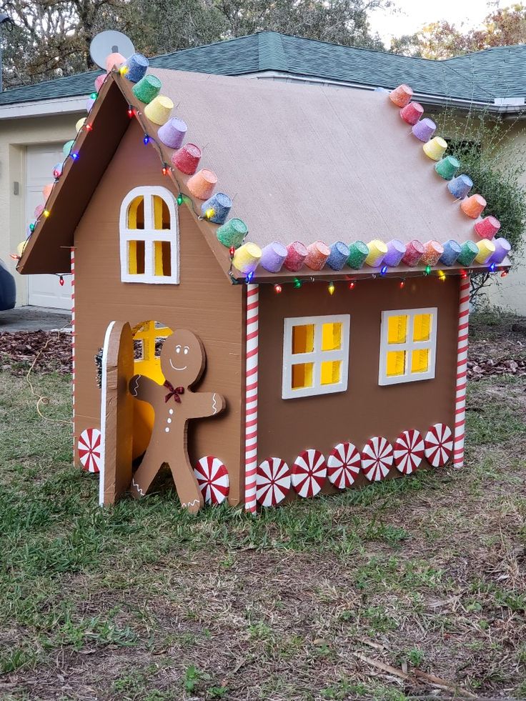 a gingerbread house with candy canes on the roof and decorations all around it