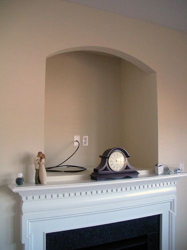 a clock on top of a mantle in a living room