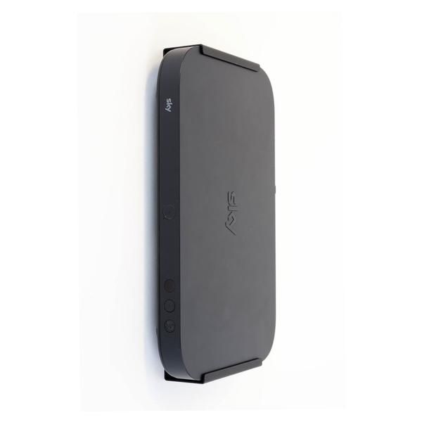 the back side of an external hard drive case on a white wall with black trim