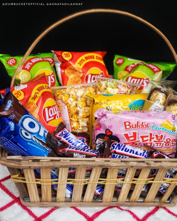 a basket filled with candy and snacks on top of a table