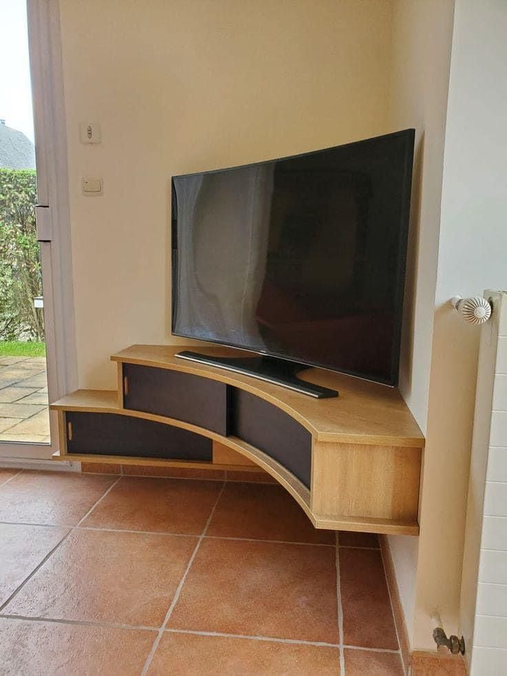 a flat screen tv sitting on top of a wooden entertainment center next to a sliding glass door