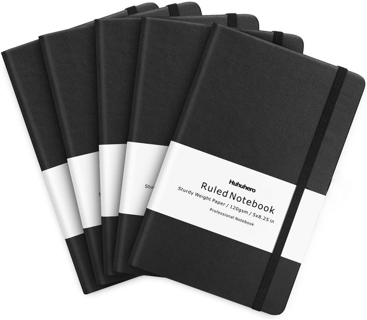 four black and white notebooks are stacked on top of each other