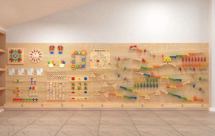 a room filled with lots of wooden pegs on the wall next to bookshelves