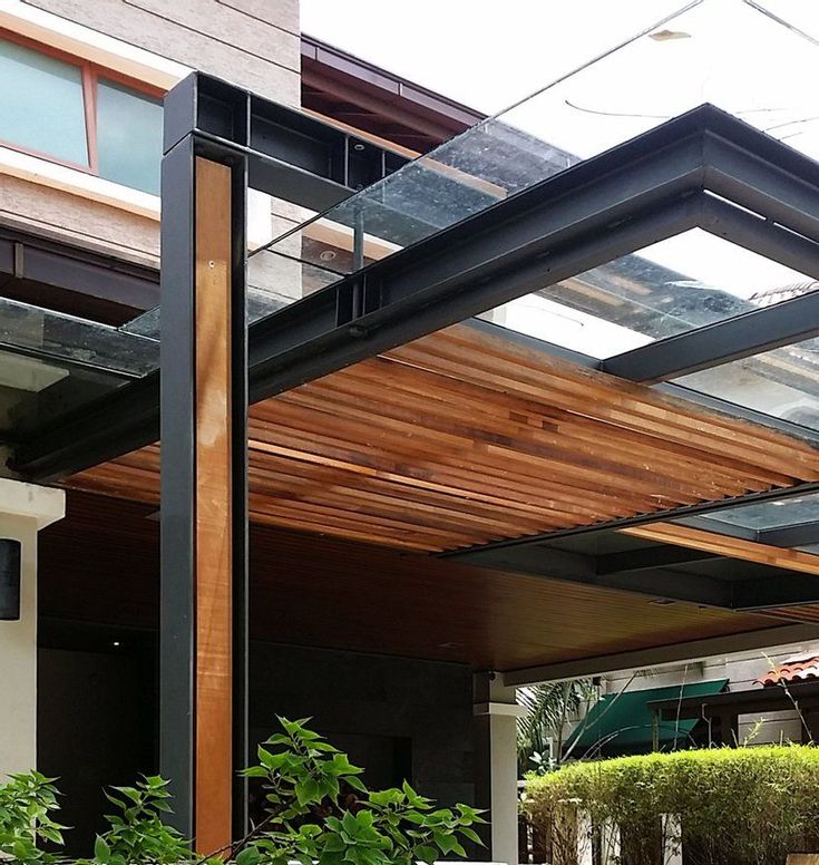 an outdoor covered patio with potted plants and trees