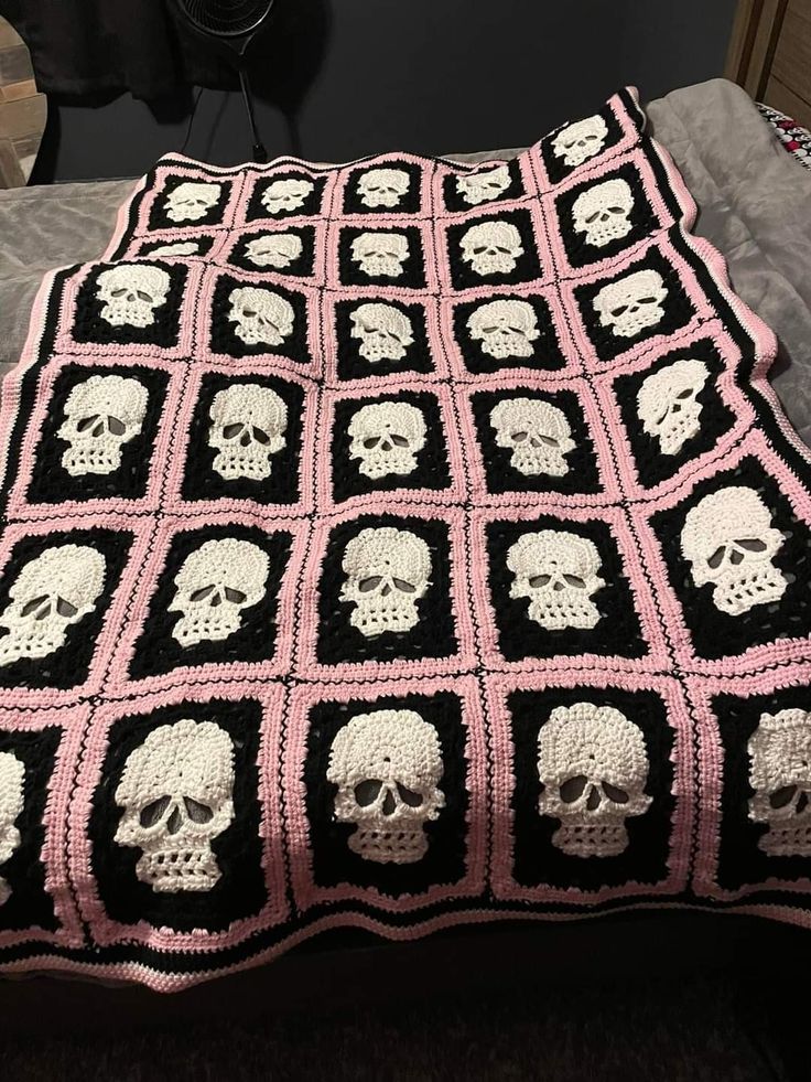 a crocheted blanket with skulls on it