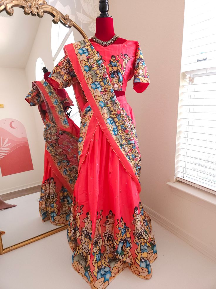 Elevate your ethnic wardrobe with our exquisite Dola Silk Kalamkari Lehenga. This luxurious ensemble combines the rich texture of Dola silk with the timeless beauty of Kalamkari art, making it perfect for festive occasion and wedding Blouse will have 3 to 5 inches of extra allowance Model is wearing size XL or 42 size. Disclaimer:The actual color may vary slightly due to different screen calibration.Since this product is handwoven, there might be slight irregularities and unevenness in the weave, pattern or selvedge. But isn't it wonderful that nobody else will ever own this beauty, handcrafted just for you Festive Slub Silk Sharara With Pallu, Embroidered Slub Silk Sharara With Traditional Drape, Traditional Slub Silk Sharara With Resham Embroidery, Bollywood Style Slub Silk Salwar Kameez With Pallu, Red Slub Silk Sets For Festivals, Traditional Sharara With Resham Embroidery, Anarkali Slub Silk Choli For Festivals, Navratri Slub Silk Traditional Wear With Dupatta, Traditional Red Slub Silk Sets