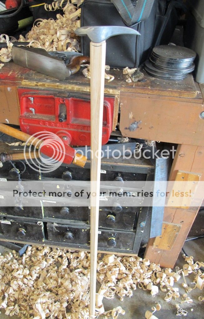 an old toolbox is sitting on top of wood shavings