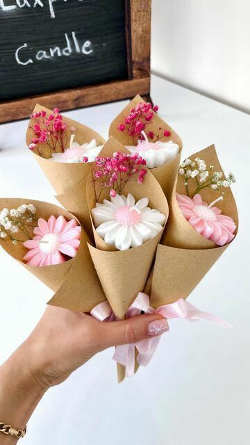 a person holding a bunch of flowers in their hand