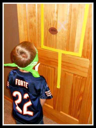 a young boy wearing a football jersey standing in front of a door with the number 22 on it