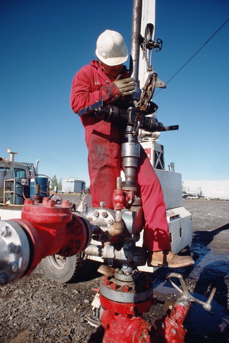 a man working on a red fire hydrant