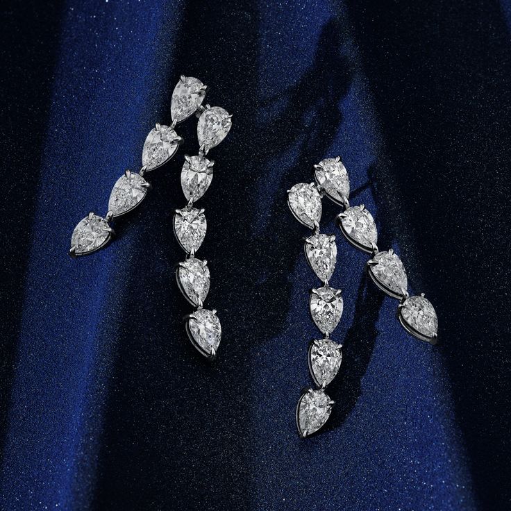 Adorn yourself with elegance in our Pear Shape Diamonds Drop Earrings. Each diamond, fashioned into a captivating pear shape, gracefully descends in a sophisticated bar setting. Luxury Pear-shaped Diamond White Earrings, Luxury Pear-shaped Diamond White Diamond Earrings, Pear-shaped Diamond Earrings For Formal Events, Luxury Pear-shaped Diamond Earrings For Evening, Luxury Pear-shaped Brilliant Cut Diamond Earrings, Luxury Dangle Teardrop Earrings For Anniversary, Luxury Pear-shaped Earrings For Formal Events, Luxury Pear-shaped Earrings For Formal Occasions, Formal Pear-shaped Bridal Earrings With Brilliant Cut