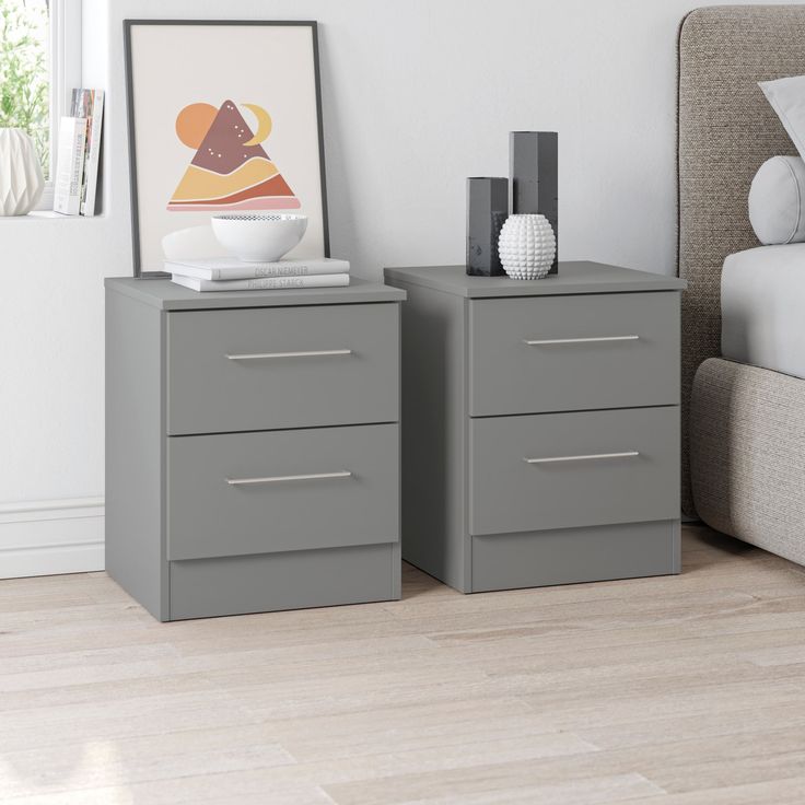 two gray nightstands in a bedroom next to a bed