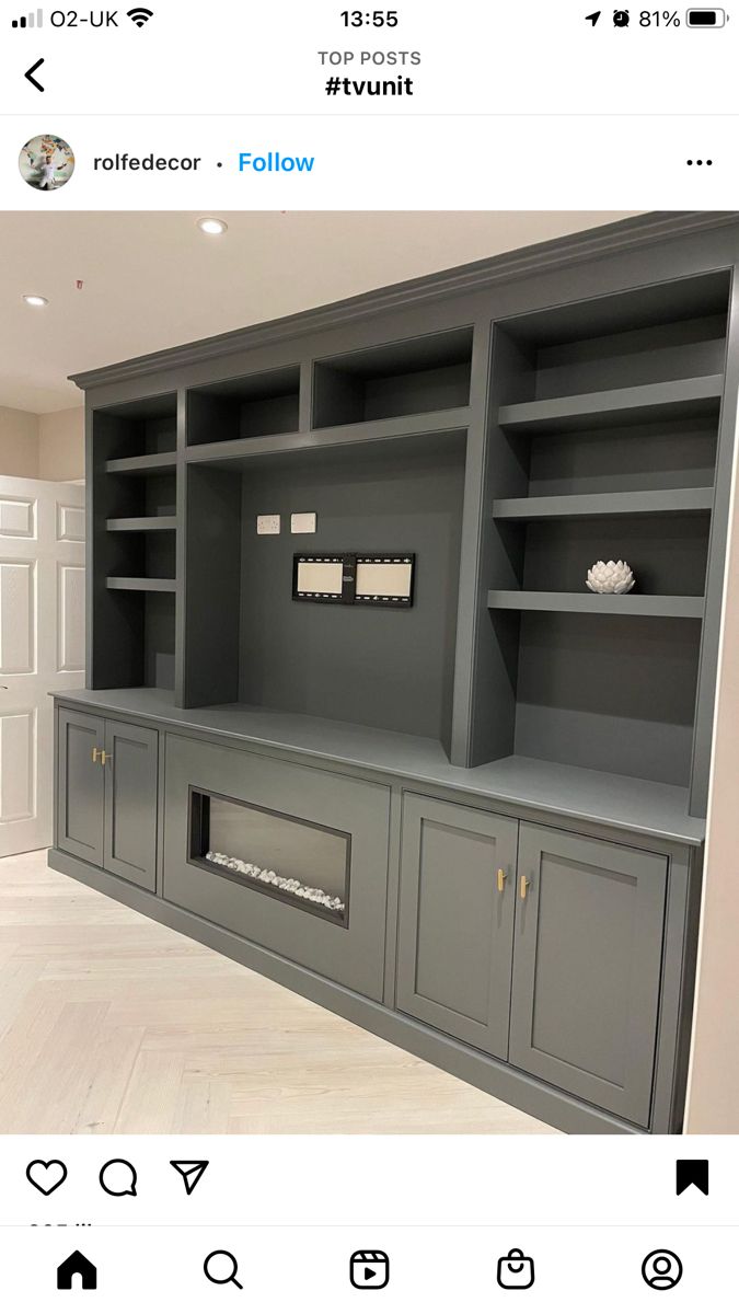 an empty room with built in bookshelves and cabinets on the wall above it