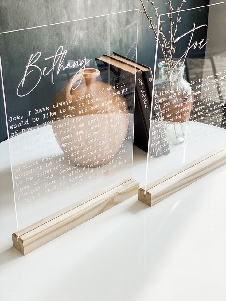 two clear acrylic vases sitting on top of a table