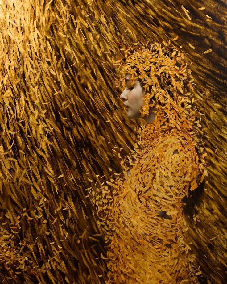 a woman is standing in front of a large amount of gold flakes on the ground