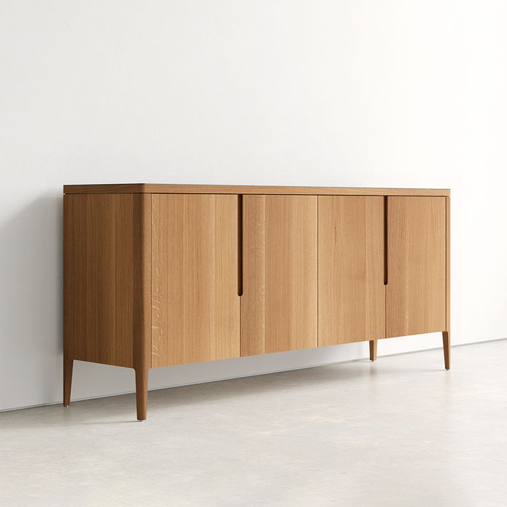 a wooden cabinet against a white wall in an empty room