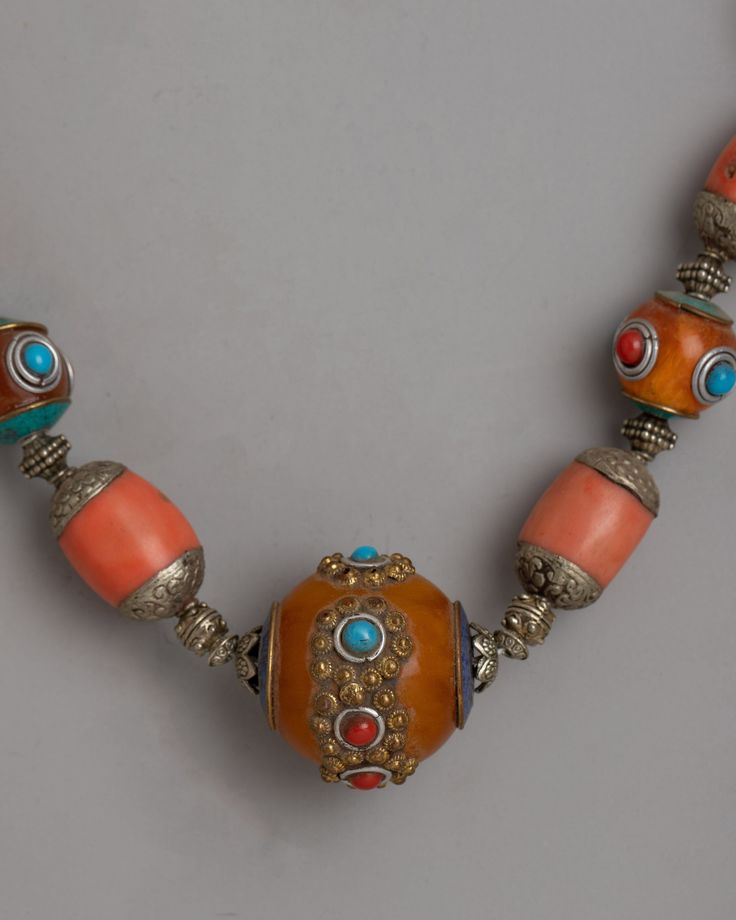 Tibetan Amber Necklace About our LocketThe Tibetan Amber Necklace is a real masterpiece, delicately made from white gold and plated with exquisite silver. Each gorgeous amber bead, recognized for its warm and inviting hue, is delicately knotted alongside brilliant coral and turquoise stones, resulting in a captivating blend of colors and textures reminiscent of Tibetan workmanship and tradition. Handcrafted with meticulous care to detail, this necklace oozes timeless beauty and cultural history. Rituals Set, Maitreya Buddha, Green Tara, Amber Necklace, Amber Beads, Conch Shell, Mala Beads, Conch, Turquoise Stone