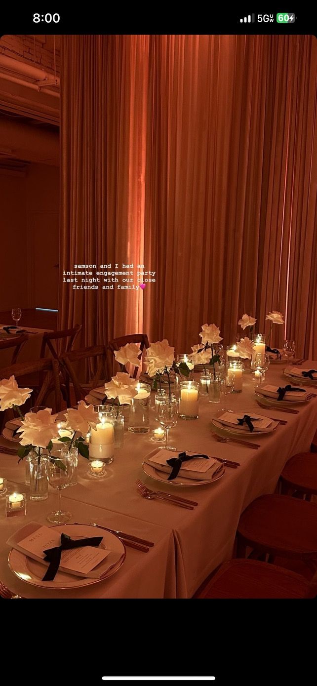 a long table is set with candles and flowers on it for an elegant dinner party