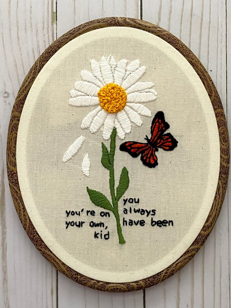 a white daisy with a butterfly on it and the words you're on always your own, have been kid