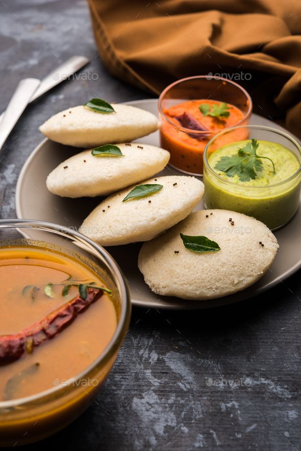 some food is on a plate with soup and sauces next to it - stock photo - images