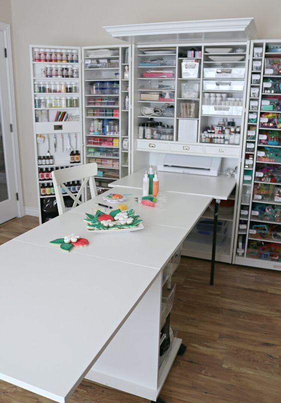 a white table in a room with lots of crafting supplies