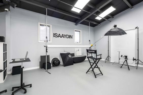 an empty studio with chairs and lighting equipment