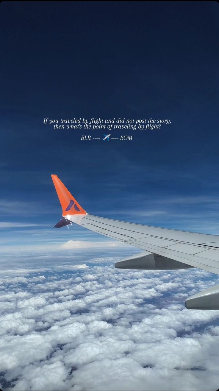 an airplane wing flying above the clouds with a quote written on it's side