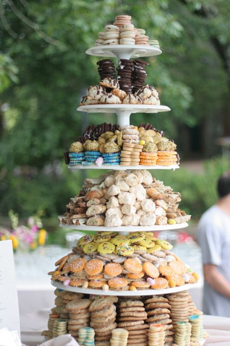 three tiered trays filled with different types of donuts