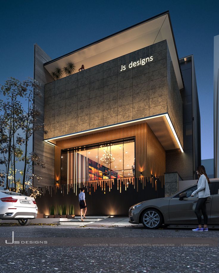 two people are standing in front of a building that has been designed to look like it is lit up at night