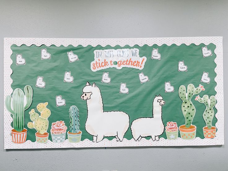 a bulletin board with two llamas and cactuses