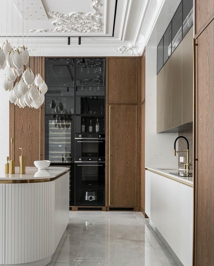 the kitchen is clean and ready to be used for dinner or party purposes, it's all white with gold accents