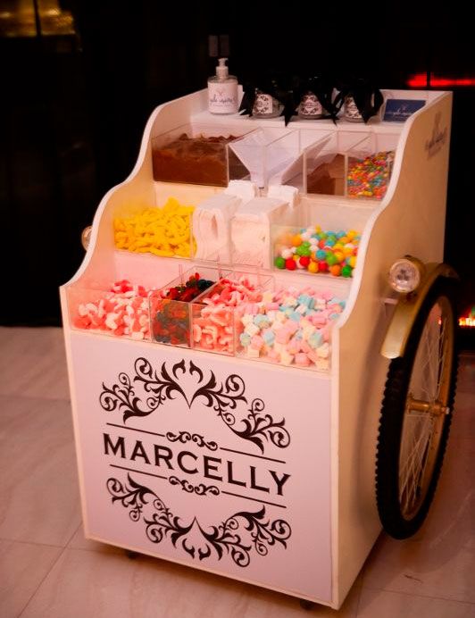 an ice cream cart with candy and candies on it