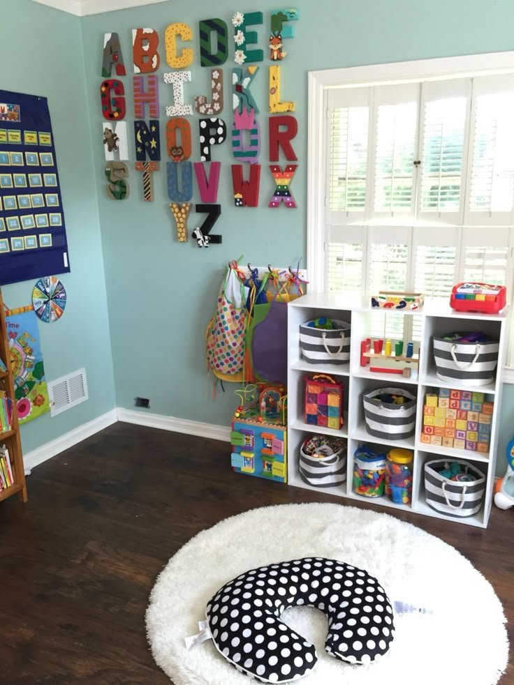 a child's playroom with toys and bookshelves