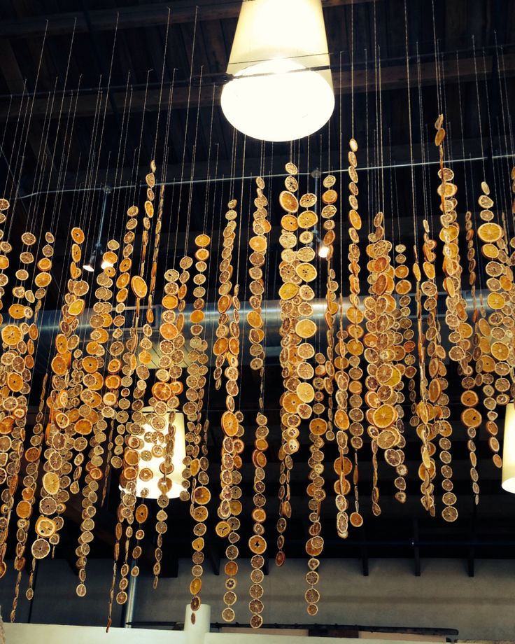 a chandelier made out of gold coins hanging from the ceiling in a building