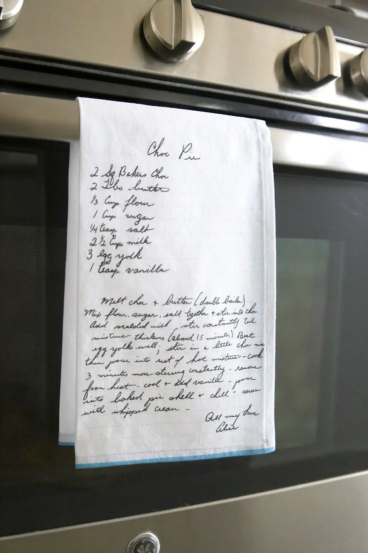 a piece of paper that is on top of an oven door with writing on it