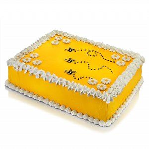 a cake with yellow frosting and white decorations