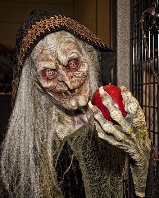 a creepy looking person holding an apple