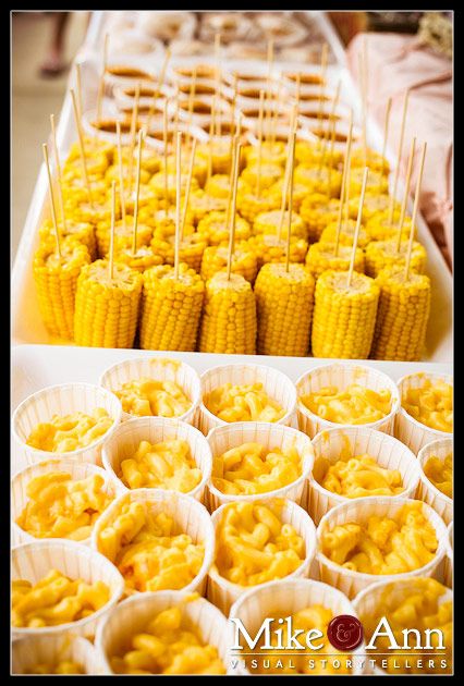 corn on the cob and cupcakes are arranged in paper cups for display