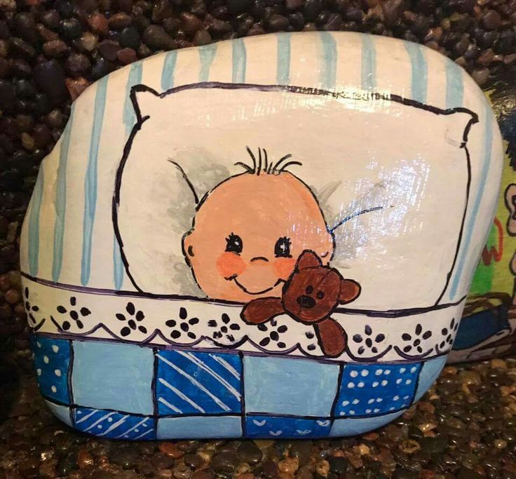 there is a painted rock with a baby on it