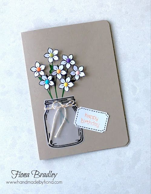 there is a card with flowers in a jar on the front and tag on the back