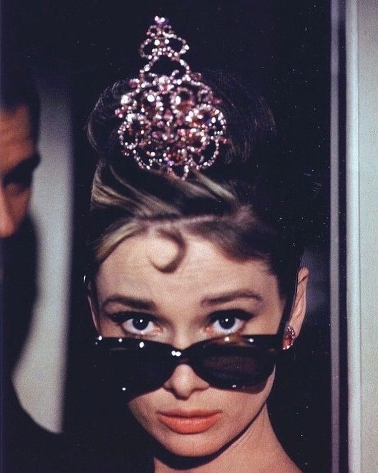 a woman wearing sunglasses and a tiara