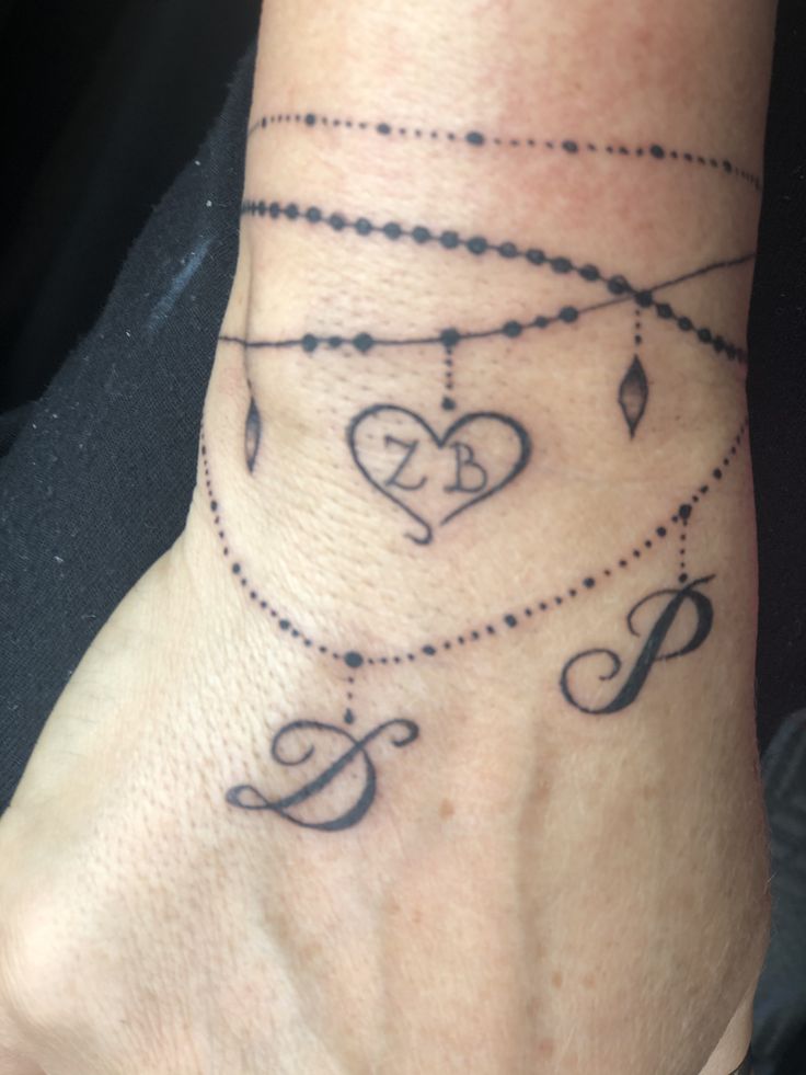 a woman's foot with tattoos on it and the word love written in cursive writing