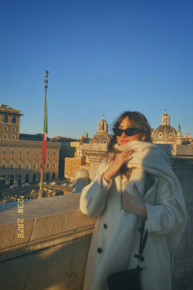 a woman standing on top of a bridge