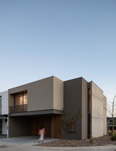 a person walking in front of a house