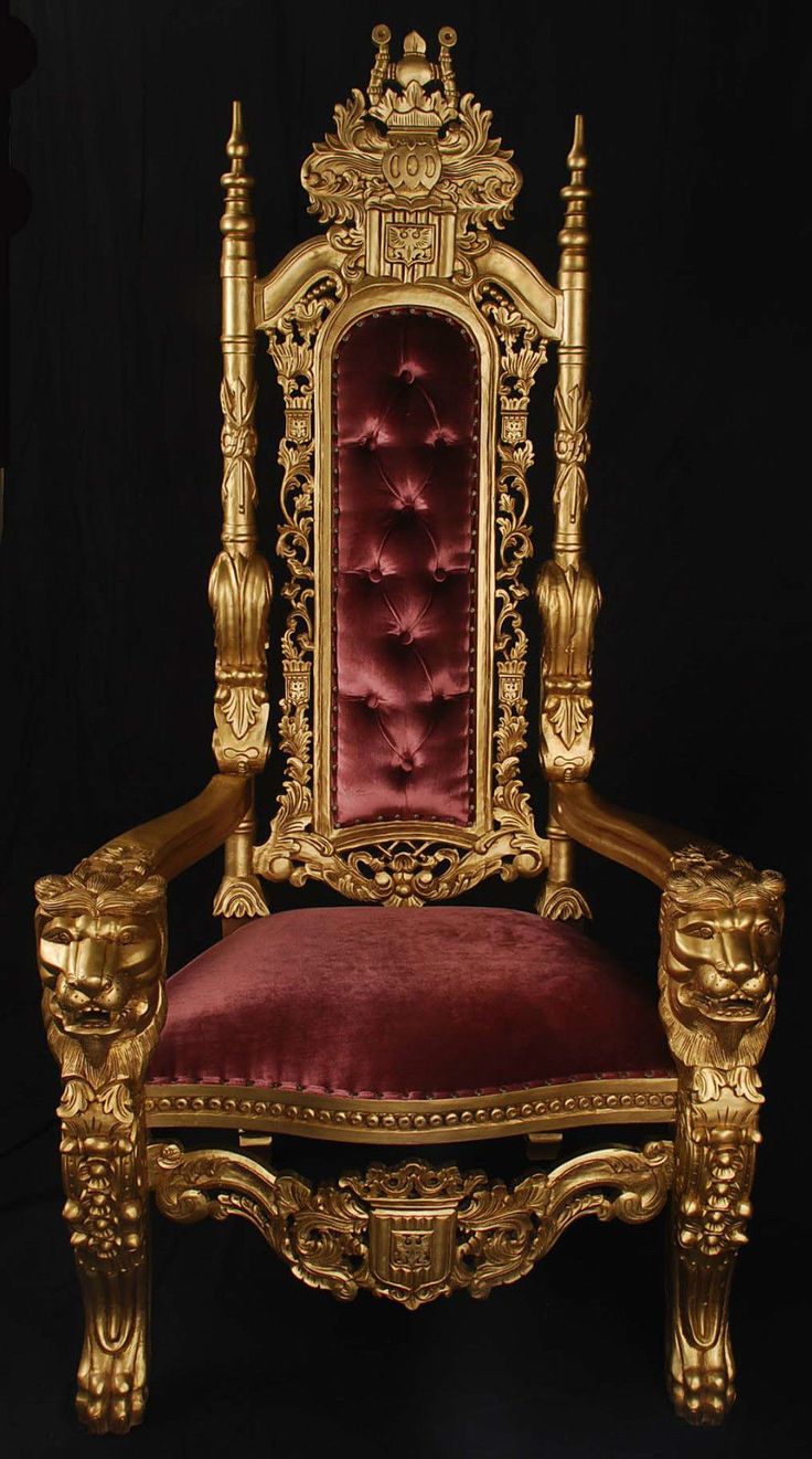 an ornate gold chair with red velvet upholstered on the armrests and back