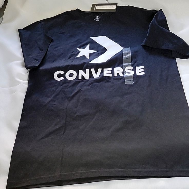 Black Converse T-Shirt Never Used Black Crew Neck T-shirt With Logo Print, Black Casual Pre-shrunk T-shirt, Converse Graphic Print Short Sleeve T-shirt, Sporty Black T-shirt With Screen Print, Black Short Sleeve Branded T-shirt, Black Cotton Shirt With Branding, Converse Cotton Crew Neck T-shirt, Converse Cotton Graphic Tee, Converse Graphic Tee Crew Neck Top