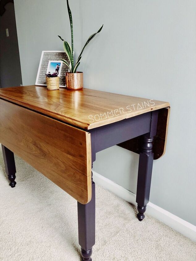 a desk with a potted plant sitting on top of it