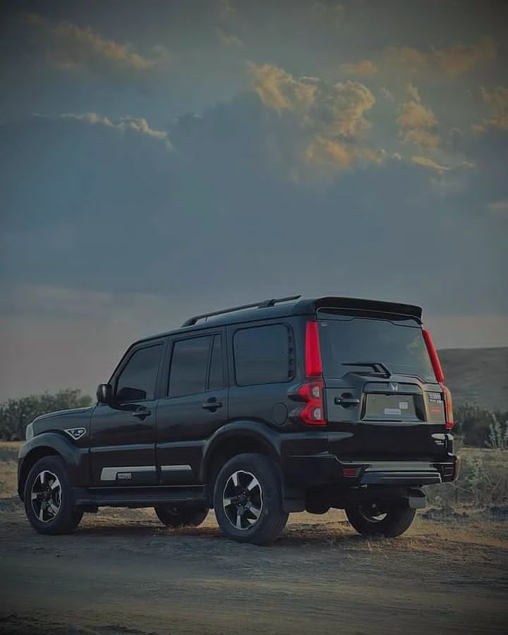 a black suv is parked in the desert